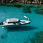 Axopar 37 XC Cabin cruising off the coast of Syvota under clear skies