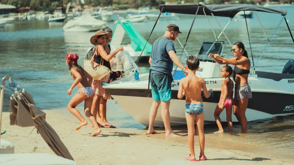 Family boarding a motorboat directly from a beachfront resort
