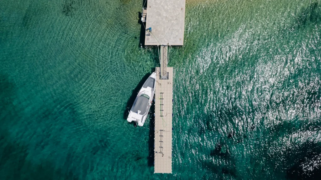 Guests boarding several boats at a luxury seaside dock for a private group cruise