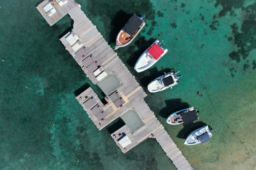 Private boat moored at the Ekies Resort beach jetty in Vourvourou, Sithonia — departure point for boat trips and rentals with Explore Boat Trips, Halkidiki